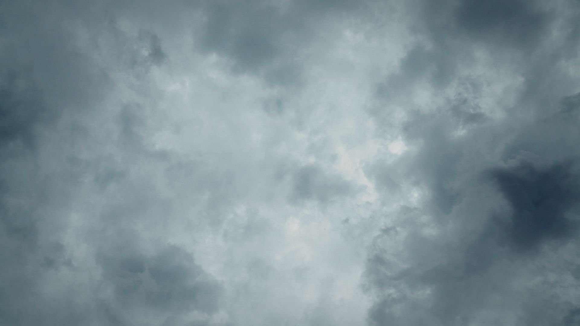 Dramatic gray and white storm clouds filling the sky overhead